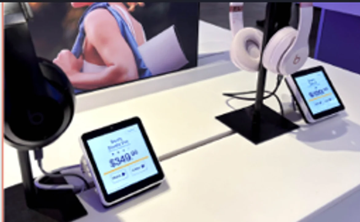 A 4-inch Ally touchscreen beside headphones in a retail display