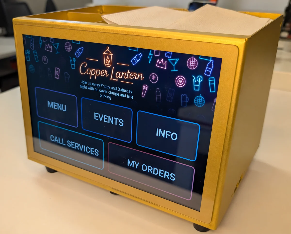 A touchscreen integrated into a tabletop napkin holder