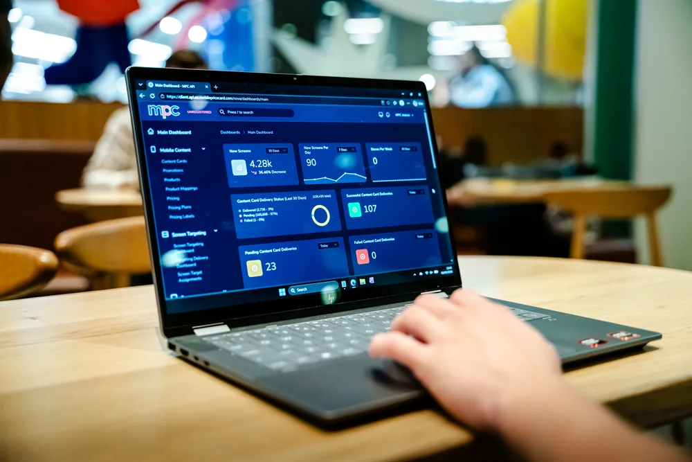 The MPC dashboard showing content delivery status on a laptop