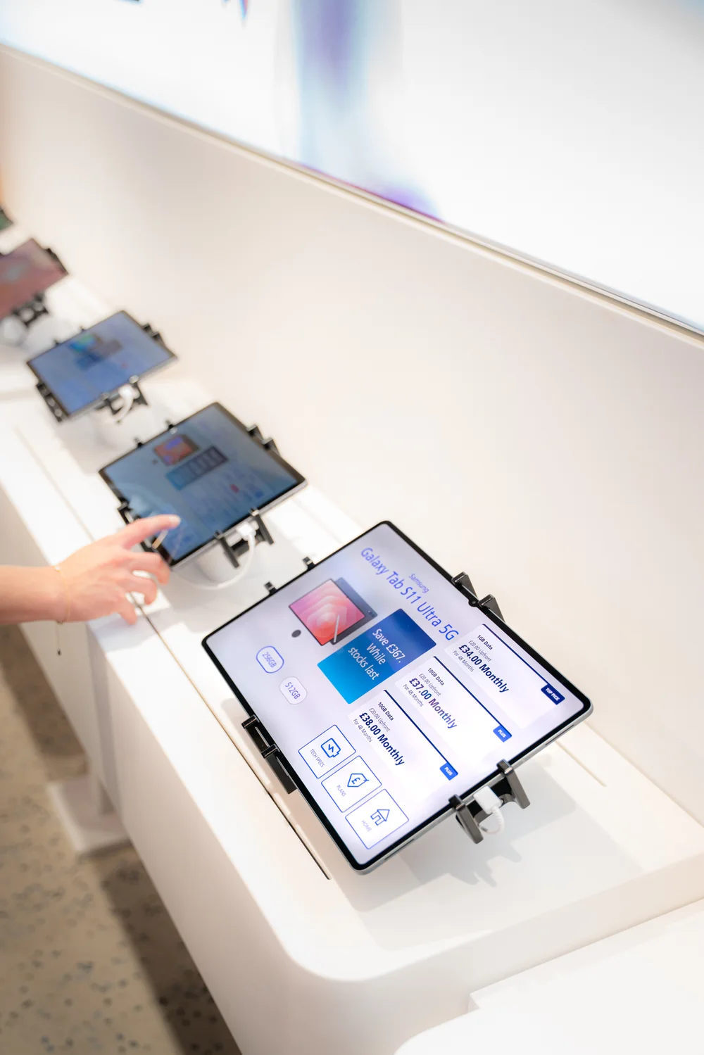 Samsung tablets displaying product information and pricing in store