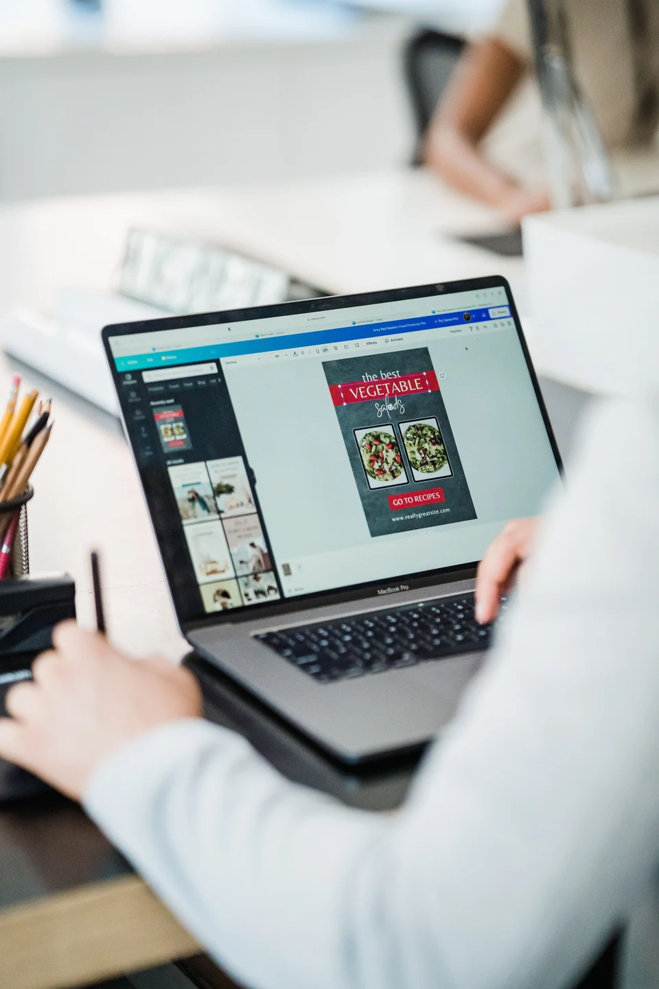 A retail team member preparing campaign content on a laptop